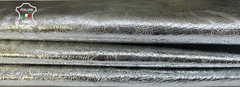 Metallic silver crinkled Italian goatskin leather hide, 4 sq ft, 0.7mm thick, showcasing textured, shiny leather for crafts.