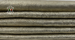 Two skins of metallic platinum crinkled calf leather from Italianskins, showcasing a textured, washed finish for leathercraft projects.