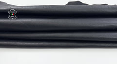 Washed black vegetable tan lambskin leather skins, high-quality goatskin leather from Italianskins, showing smooth texture and natural finish.