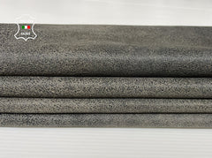 Black crackle finish on beige stonewash vintage Italian lambskin leather skin, showcasing textured, supple Italian leather material.