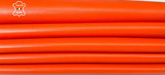 Bright orange Italian lambskin leather skins from Italianskins, showcasing soft, textured leather with natural grain detail.