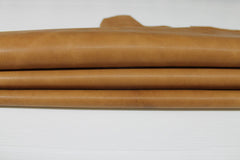 Light tan vegetable-tanned Italian goatskin leather skins from Italianskins, showing smooth textured surface and natural leather grain.