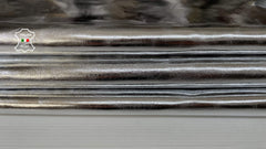 Shiny metallic silver Italian goatskin leather skin with smooth texture and natural grain, showcasing high-quality Italian craftsmanship.